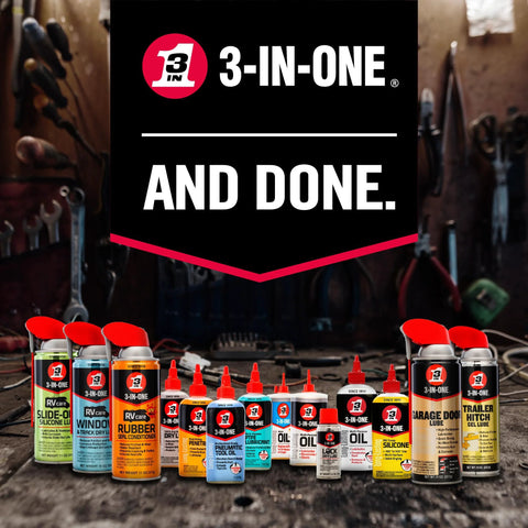 A variety 3-IN-ONE lubricant cans and bottles displayed on a workbench, including Garage Door Lubricant With Adjustable Spray For Wide Or Narrow Application 11 Oz Quick Drying Non Sticky Formula Protects Metal Moving Parts From Friction And Corrosion Highly Durable High Performance Lubricant For Smooth Operation And Longer Door Life.