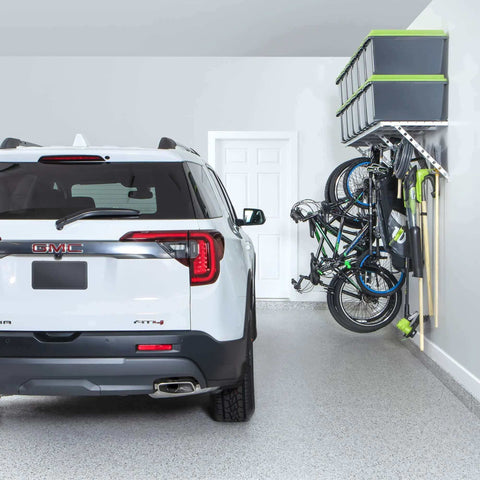 96 Inch Wide Wall Mounted Utility Storage Rack With 4 Bike Hooks And 20 Regular Hooks in a garage, holding bikes and tools