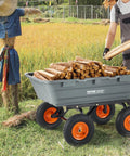 Person loading wood into 1200 lb 7 Cu Ft Garden Dump Cart with 2 in 1 Convertible Handle 13 Inch All Terrain Wheels near scarecrow.