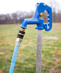 Brass Quick Hose Connect With Auto Shutoff When Disconnected For Garden Hoses attached to a blue outdoor water spigot