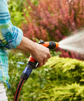 Person using Garden Hose Quick Connectors Set With Four Male And Four Female Fittings And Four Faucet Adapters, 3/4 Inch in garden