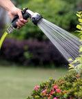 Person using stainless steel garden hose quick connect fittings with quick release for easy hose attachments and swapping sprayers, three quarter inch GHT universal connector, save wrist strain and time during lawn care in garden.