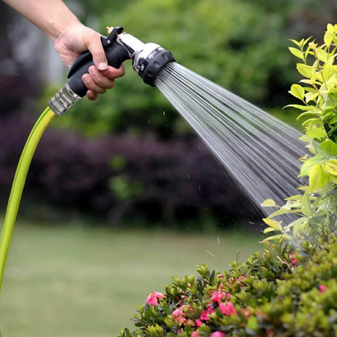 Person using stainless steel garden hose quick connect fittings with quick release for easy hose attachments and swapping sprayers, three quarter inch GHT universal connector, save wrist strain and time during lawn care in garden.