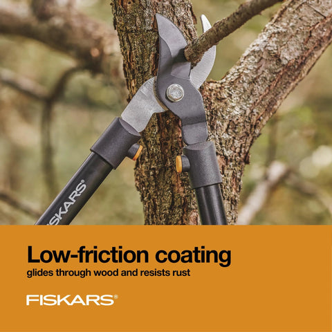Heavy Duty 28 Inch Garden Loppers With Rust Resistant Bypass Steel Blade cutting a tree branch in a garden setting.