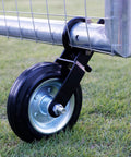 Close-up of Heavy Duty Gate Wheel Caster Kit for Chain Link Fence Swing with 6 inch wheel mounted on a metal frame outdoors.