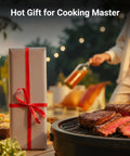 Wrapped gift and grilling steak outdoors with someone holding a beverage in the background, blurred setting sun.