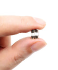 Person holding Fast-Blow Mini Fuse F2.5AL, 2.5A 125V Glass Fuse, 10 Pack, 0.39 x 0.14 Inch (10 x 3.6 mm), showing compact size.