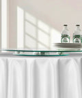 20 Inch Glass Lazy Susan Turntable with bottles and plates on a dining table, round clear tempered glass rotating tray, smooth silent 360 rotation.