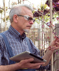 Man wearing Glasses Side Shields for Eye Protection TPU Shields for Small to Medium Eyewear examines plants outdoors