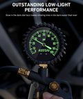 Tire Pressure Gauge With Inflator 0-100 PSI ANSI B40.1 Accuracy Large 2.5 Inch Glow Dial in use, showing glowing gauge needles and numbers close-up.