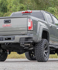 Rear view of a GMC pickup truck equipped with 4.5-8 Inch N3 Rear Shock Absorbers For 07-24 Chevy And GMC 1500 Pickup Trucks