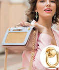 Woman holding purse featuring Rotatable Ball Post Head Buttons Set of 12 Pieces With D Ring Metal Rings; gold tone finish.