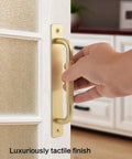 Hand holding a 2 Pack Gold 7 Inch Barn Door Handle For Sliding Closet Doors With Backplates And Drawer Pulls Premium Cabinet Knobs