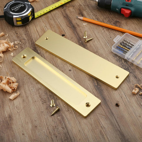 2 Piece Sliding Barn Door Closet Handles Set With Gold Coating, 6 inch rectangular finger pulls with screws on wooden surface
