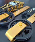 Components of Big Wheel Barn Door Hardware Kit For Sliding Track Set With Large Rollers And Gold Finish Handle Bar Finger Pull Plate And Floor Guide Heavy Duty Interior Closet And Room Doors Track Length Six Feet Door Not Included.