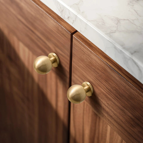 One Inch Gold Ball Cabinet Knobs Set Crafted From Solid Brass With Hand Brushed Finish installed on wood cabinets