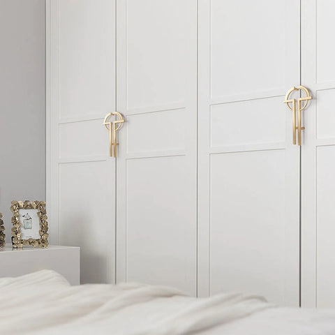 2 Pack Gold Zinc Alloy Cabinet Pulls on white closet doors showcasing modern minimalist design for office furniture renovation