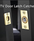 Close-up of KTV door latch catcher in a brass finish, featuring a ball and socket mechanism installed on a black door.