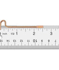 Close-up of a gold finish emergency pin on a ruler, part of a Gold Finish Ten Pack Emergency Pins For Kwikset Privacy Bedroom And Bathroom Door Levers And Knobs Compatible With Kwikset Interior Privacy Doors With Small Center Access Hole Durable Steel Release Tools For Quick Access And Safe Unlocking Ten Pack.