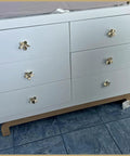 Six Pack 2.4 Inch Gold Flower Cabinet Knobs Set on white dresser showcasing vintage floral petal pulls.