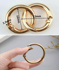 50 Pack 1 Inch Metal Spring O Rings Set with Round Carabiner Clips Snap Hooks in Gold Finish, shown in close-up and handheld.