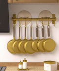 Kitchen Utensil Holder Hanger, Pot and Pan Rack Wall Mounted with 8 Hooks, Gold, holding golden pans in a kitchen setting.