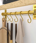 Gold Kitchen Utensil Holder Hanger with 8 Hooks, Wall Mounted Pot and Pan Rack holding cooking utensils and towel
