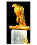 Gold sculpture of a falcon on a textured pedestal, showcasing a metallic finish and intricate details