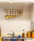 Kitchen Hanging Racks 304 Stainless Steel 20 Inch Rail Utensil Storage Hanger with golden finish and measuring spoons above sink