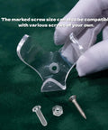 Close-up of transparent acrylic claw for Golf Ball Wall Mount Display with screws on green surface