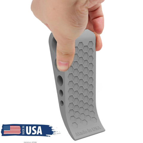 Hand holding gray door stopper with honeycomb design, Door Stoppers for Bottom of Door Premium Floor Rubber Door Stop Wedge Made in USA