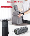 Vibrating Foam Roller For Back Pain Relief With Five Speed Settings being packed into a backpack, travel-friendly gray design.