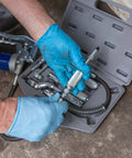 Mechanic using Versatile Grease Lubrication Adapter Kit With 12 Inch Hose And Quick Connect Couplings, Rubber Tip And Needle Nozzles