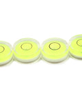 Four compact green round mini spirit levels with clear acrylic housings deliver precise bubble readings for tiny projects.