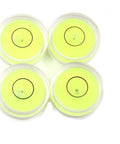 Four compact green round mini spirit levels with clear acrylic housings deliver precise bubble readings for tiny projects