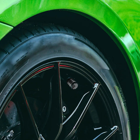 Close-up of tire with Five Pack Tire Valve Stem Cap Covers With Metal Shell And Plastic Liner Anti Corrosion Leak Proof American Flag Design