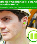 Man wearing green foam earplugs at work site; 200 Pairs Foam Earplugs For Noise Reduction 32dB Disposable Ear Plugs