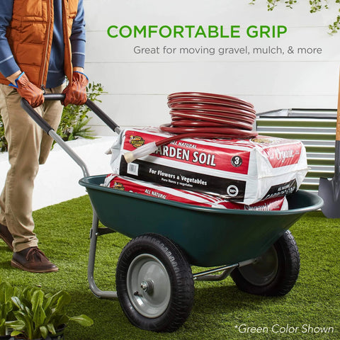 Person using green dual wheel garden cart with a load of garden soil and hose, demonstrating comfortable grip and utility.