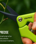 Close-up of green pruning snip from 2 Pack Stainless Steel Gardening Scissors Set With Pruning Shears And Clippers For Garden Pruning Versatile Dual Cut Pruning Combo For Delicate Flower And Shrub Trim To Thick Branches Vegetables Fruits And Landscaping.
