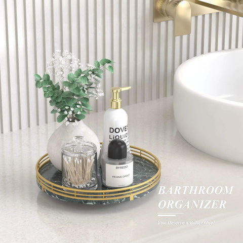 Green marble lazy susan turntable for table top, 10 inch round natural marble tray with gold frame on a bathroom countertop.