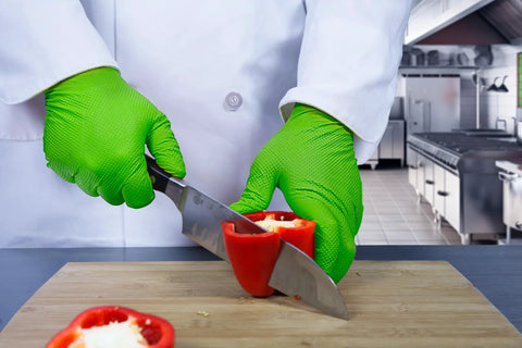 Person wearing Green Nitrile Latex Free Gloves 8 Mil Heavy Duty Raised Diamond Texture Box 100 slicing red pepper