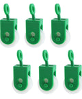 Six green nylon pulleys, one and three eighths inch diameter for outdoor clotheslines and rope pullers, smooth and durable.