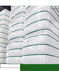 Heavy Duty PET Strapping Coil Five Eighths Inch Wide 0.035 Inch Thick, 200 Feet, 1400 Lbs Break Strength in use on white pallets.