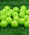 50 Pack Plastic Golf Balls Practice Limited Flight Golf Training Ball Hollow Swing Practice Indoor Balls (Green) on grass