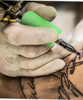 Tattoo artist using Silicone Grip Cover Sleeve For Handle Non Slip Vibration Absorbing Hand Protector on tattoo pen
