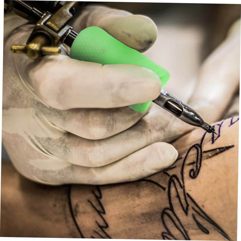 Tattoo artist using Silicone Grip Cover Sleeve For Handle Non Slip Vibration Absorbing Hand Protector on tattoo pen