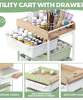 Rolling Storage Utility Cart With Four Drawers For Craft Art Supplies And Makeup Organization On The Go Mobile Cart With Green Finish And Wooden Tabletop Perfect For Kid Rooms Or Office By SYKIARIOL shown with supplies.