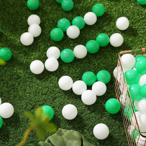 Green Ball Pit Balls - Crush Proof Plastic Balls for Ball Pit Pack of 100pcs Set for Toddlers scattered on grass with storage basket