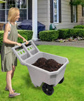2 Wheel Wheelbarrow 300 LB Capacity Heavy Duty Yard Cart with 9 Inch Solid Tires in use, showing push pull design, grey plastic tub filled with soil