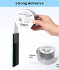 Hand holding Grey Window Screen Repair Tape 2 Inch By 30 Foot Roll For Windows Or Doors, showing adhesive fiberglass mesh tape.